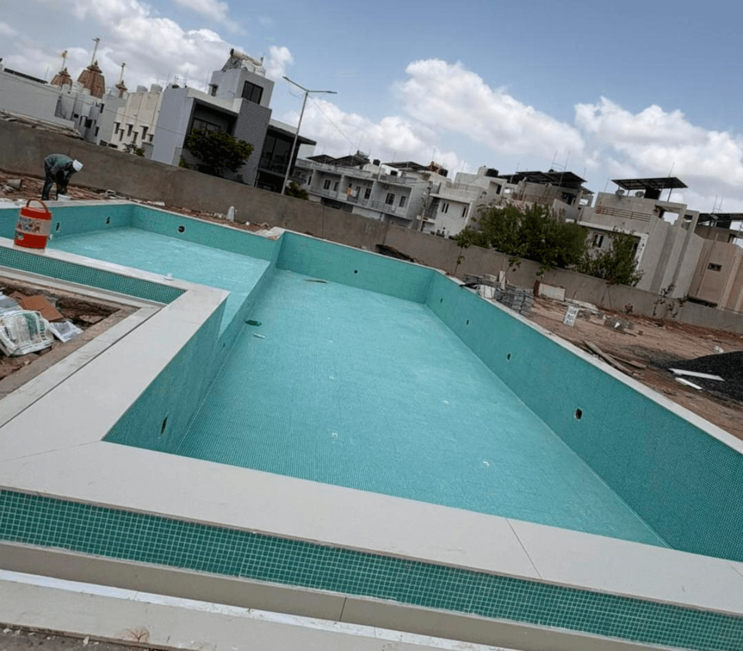 Mosaic tiling work in progress for a large outdoor swimming pool