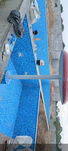 Blue mosaic tiles laid inside a swimming pool
