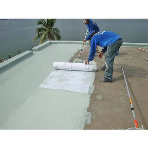 Worker rolling waterproofing membrane onto a terrace slab