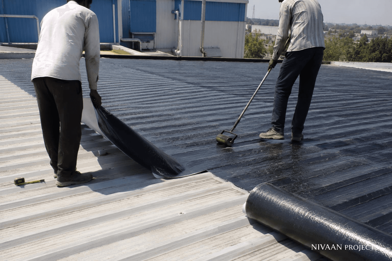Corrugated metal roof waterproofed with elastomeric bituminous coating